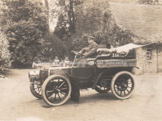 89.469 Chain-driven car with chauffeur in driving seat in the grounds of Buckingham House